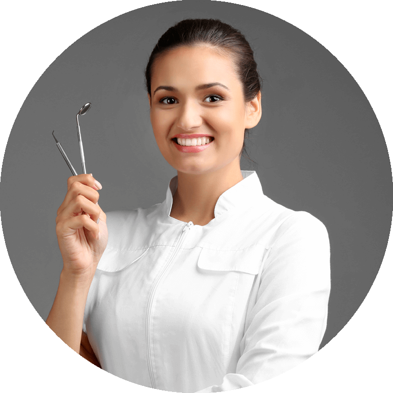 dentist smiling and holding dental tools