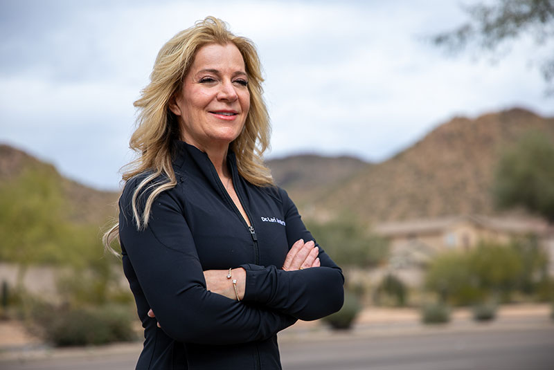 headshot of doctor smiling brightly