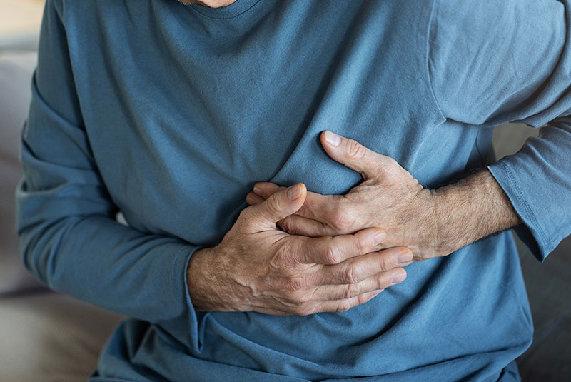 close up of mature male having chest pain