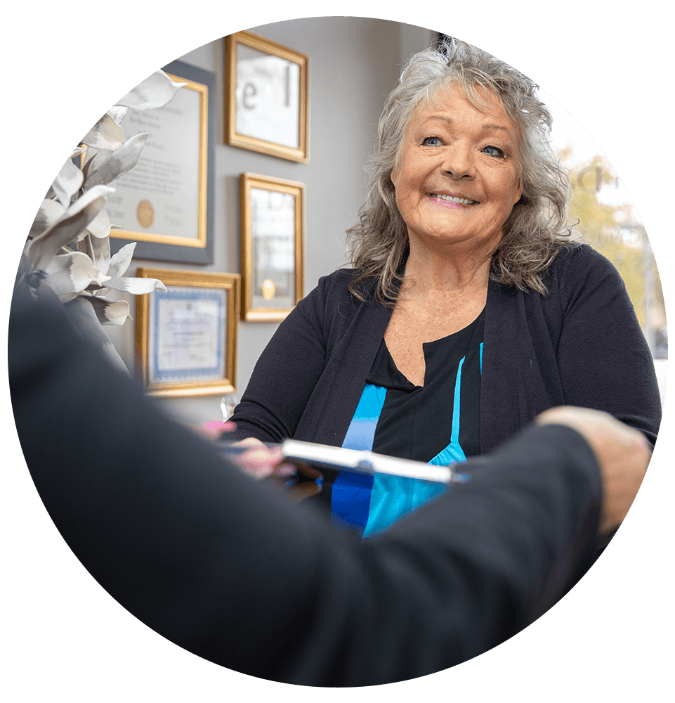 patient being helped at the front desk of the dental center