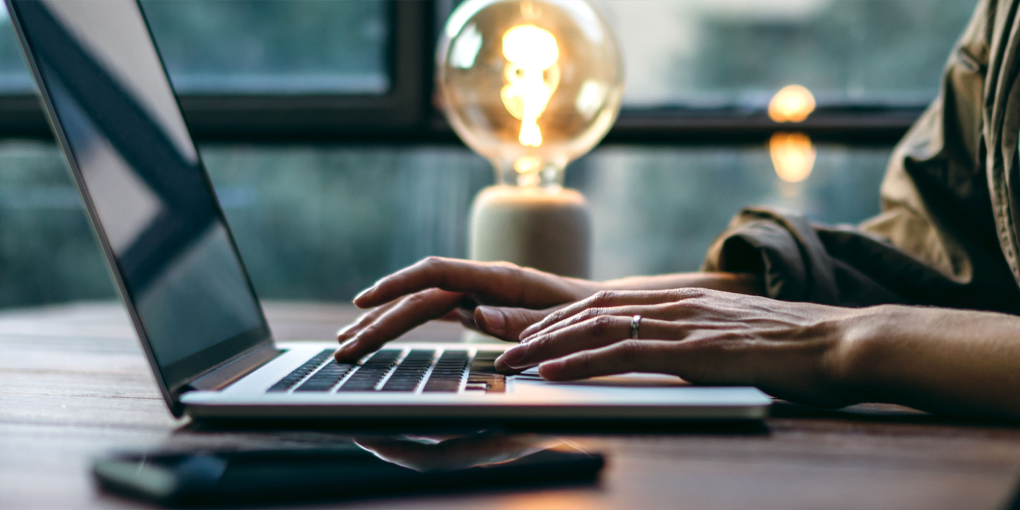 close up person writing on their laptop for their blog