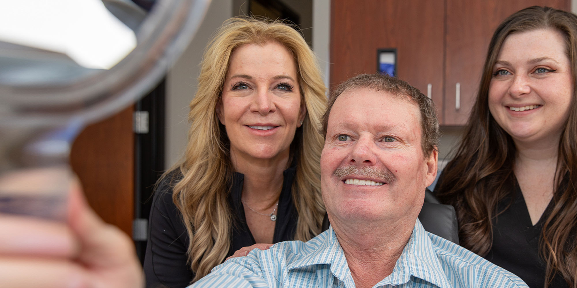dental implant patient smiling brightly after their dental procedure