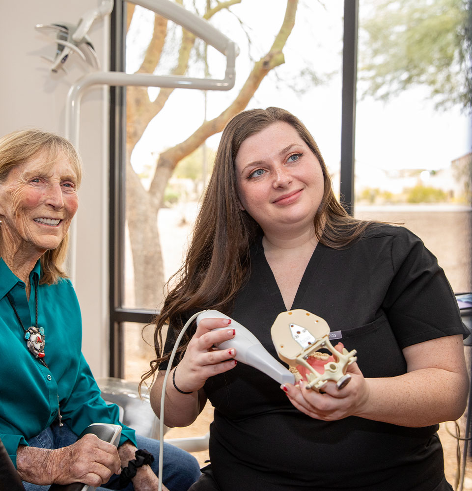 staff member and patient going over dental procedure information